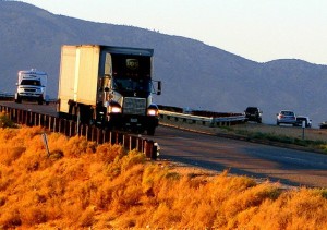 semi truck driving on a rural road