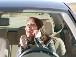 Woman with lipstick and cell phone in the car